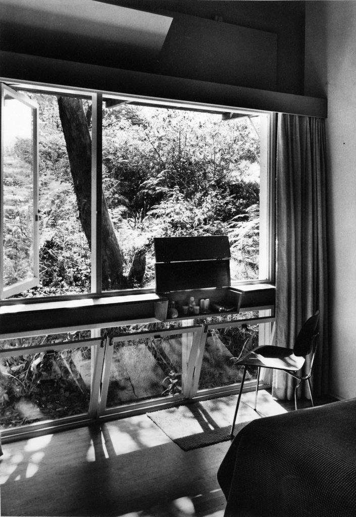 Main bedroom facing north to a steep embankment of natural bush. The dressing table was a built-in shelf as part of the window with a lift up lid with mirrors. Note the ventilation flaps above the window which enabled summertime air movement when the curtains were closed. No double glazing in those days – either not available or too expensive or, more usually not considered essential in the mild climate of Sydney. Frosts were virtually unknown.